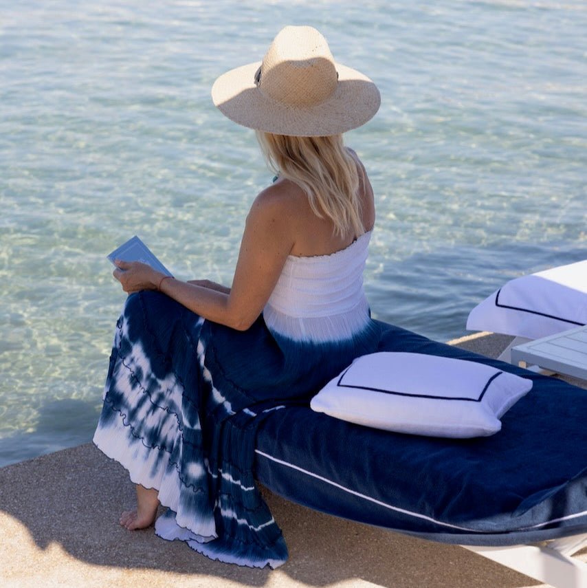 Croisiére Marine Beach Towel by Yves Delorme shown on Beach Chair by Ocean