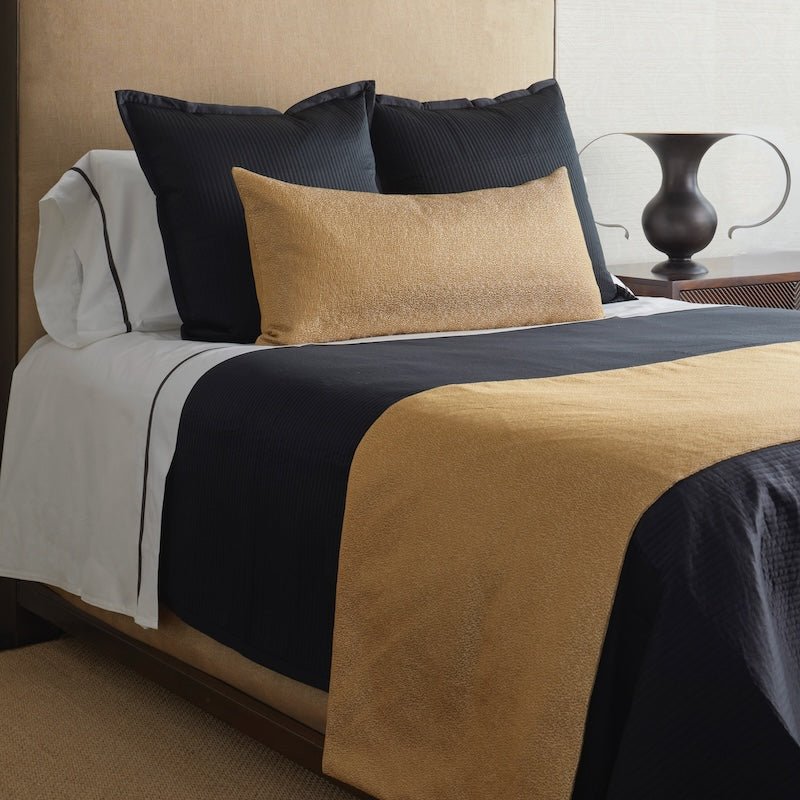 Dapple Bed Finisher Set in Gold by Ann Gish - Angle View on Black Bedding