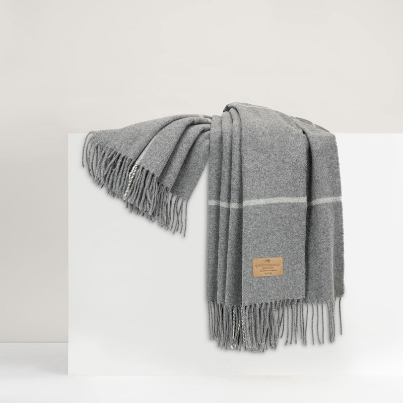 Windowpane Cashmere Throw Gray by Lands Downunder shown draped on riser