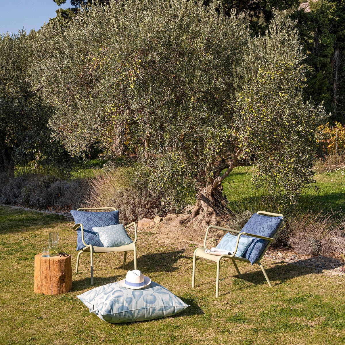 Arrière Pays Blue Outdoor Pillows by Le Jacquard Français - Lifestyle on Lawn