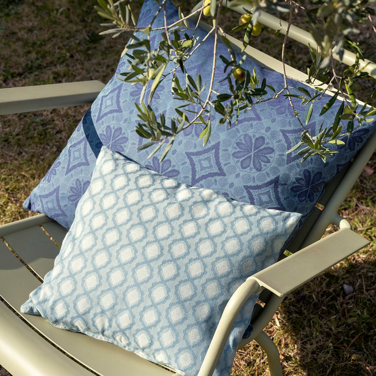 Arrière Pays Blue Outdoor Pillows by Le Jacquard Français - Lifestyle in Chair