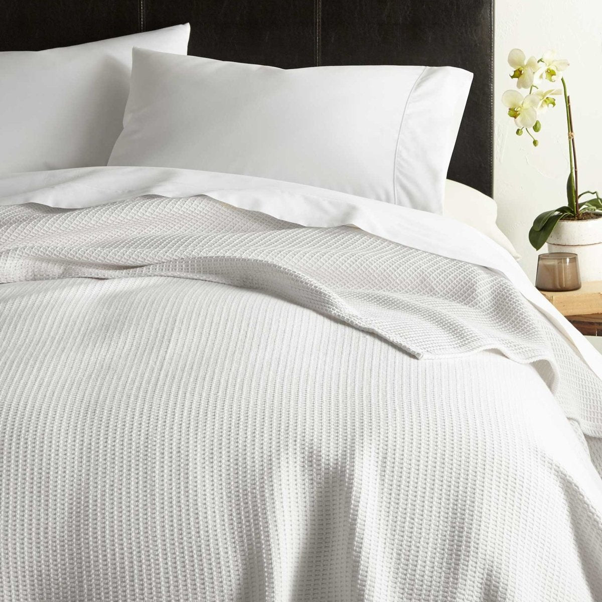 Peacock Alley Riviera Cotton Blanket shown on Bed at Fig Linens and Home