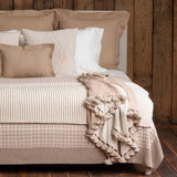 Alicia Adams Alpaca Bali Pompom Throw in Beige and Ivory shown on Bed - Fig Linens and Home