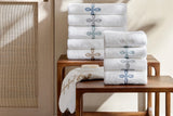 Gordian Knot Bath Towels by Matouk at Fig Linens and Home - Stack of all colors
