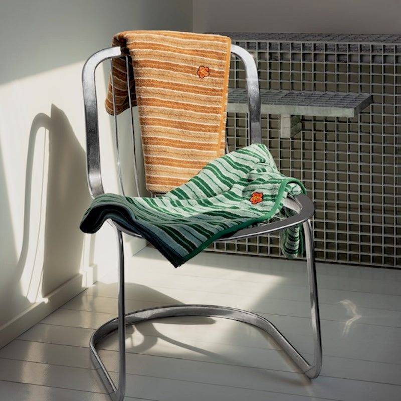 Towels shown in Chair - K Club Erable Organic Cotton Towels by Yves Delorme
