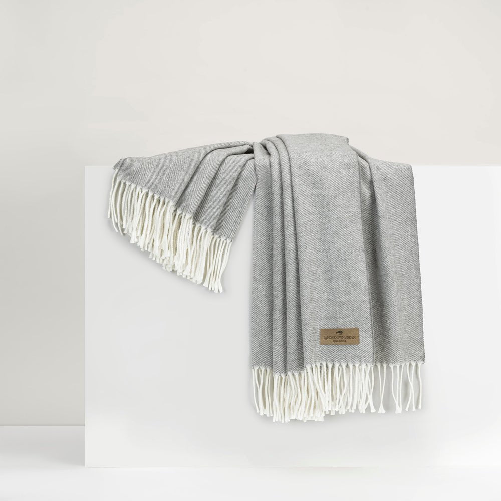 Italian Herringbone Pebble Throw | Lands Downunder Throw Blanket draped over riser in white room