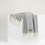 Italian Herringbone Pebble Throw | Lands Downunder Throw Blanket draped over riser in white room