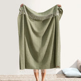 Italian Herringbone Thyme Throw by Lands Downunder - Holding throw with fringe shown