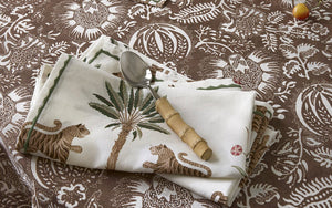 Matouk Schumacher Tiger Palm Cloth Napkin shown on Printed Table | Available at Fig Linens and Home