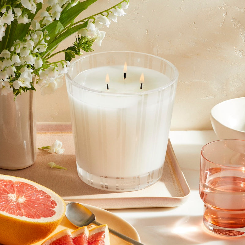 Nest New York - Grapefruit 3-Wick Candle at Fig Linens and Home - Shown with Flowers &amp; Fruit