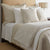 Prestige Throw Pillows Natural by Ann Gish - Square Pillows shown on Bed with Blanket and Lifestyle