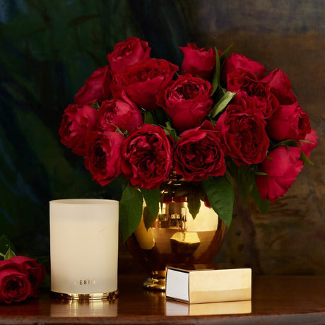 Megeve's Rose Candle 9.5 oz by AERIN shown with Vase and Roses