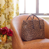 Mini Weekender Bag in Leopard by AERIN at Fig Linens and Home - View ofPurse in Swivel Chair