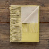 Reversible Throw French Yellow and Beige by Alicia Adams Alpaca shown on Wood