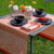 Instant Bucolique Pink Table Runner by Le Jacquard Français shown outdoor table with napkin