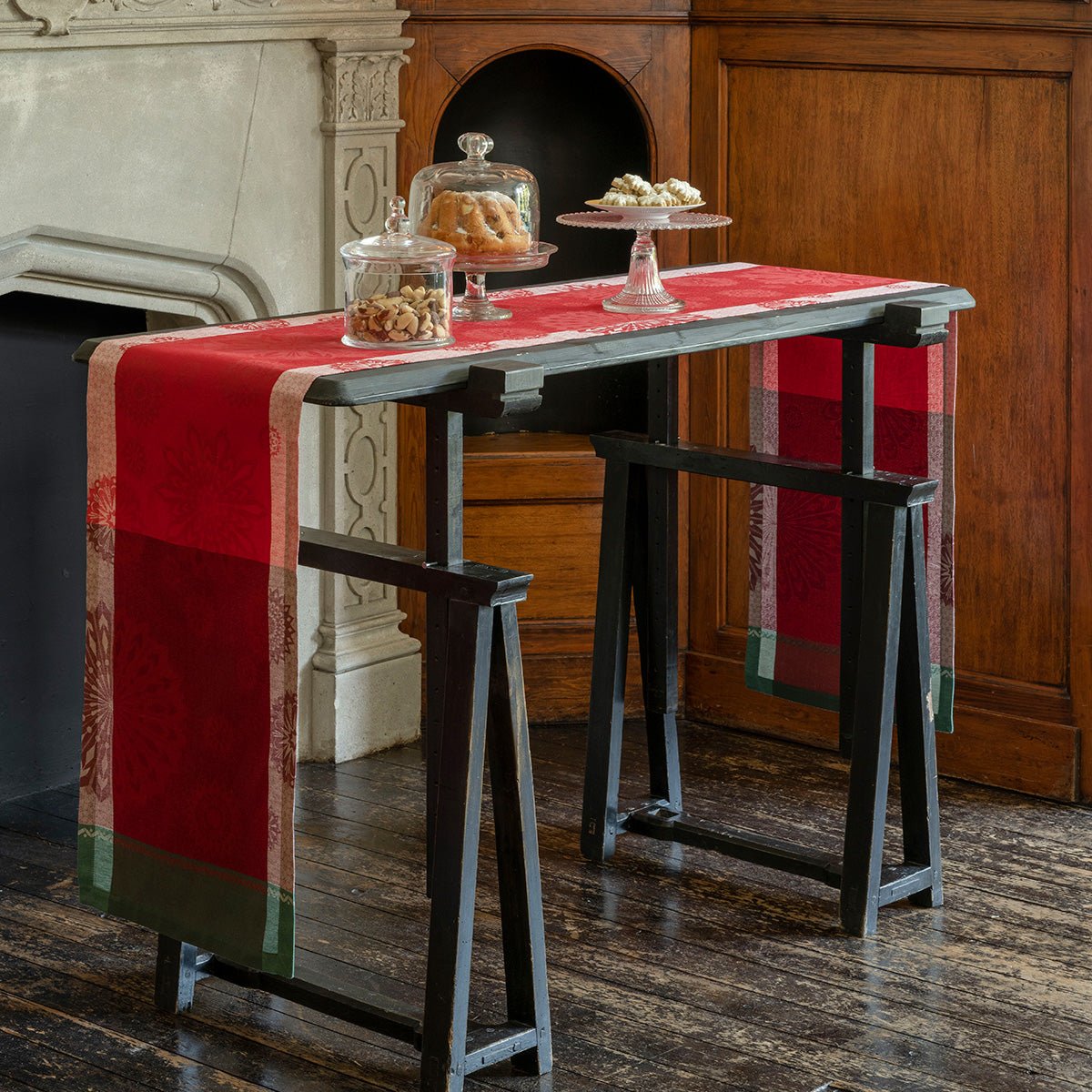 lumière d'étoiles red table runner by Le Jacquard Francais - shown on tall table