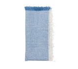 Chambray Fringe Napkin in Blue by Kim Seybert at Fig Linens and Home - Folded Napkin View