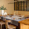 Voyage Iconique Enduit Grey Coated Tablecloth By Le Jacquard Francais at Fig Linens and Home 1