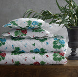 Geranium Quilts by Matouk x Tillett shown in a Stack at Fig Linens and Home