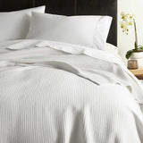 Peacock Alley Riviera Cotton Blanket shown on Bed at Fig Linens and Home