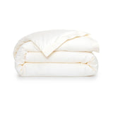 Folded Prodige Crème Bedding by Yves Delorme Couture at Fig Linens and Home