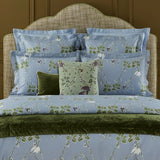 Rameau Amande Decorative Pillow by Yves Delorme shown on Bed
