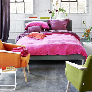 Capisoli Granite Rug - designers guild - shown with pink bedding.