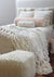 Faux fur ivory blanket on bed