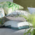 Designers Guild Manipur Silver Decorative Pillow Stacked with Linen Brera Lino