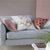 Designers Guild Manipur Coral Decorative Pillow on Sofa | Fig Linens and Home