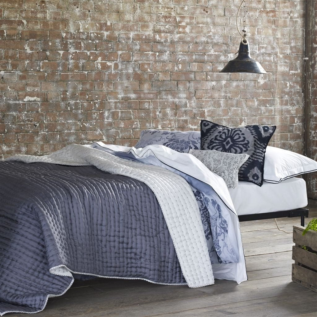 Designers Guild Chenevard Chalk & Graphite Silk Quilt shown on Bed | Fig Linens