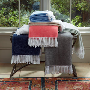 Matouk Cotton Throws - Pezzo in stack on bench | Shop Fig Linens and Home