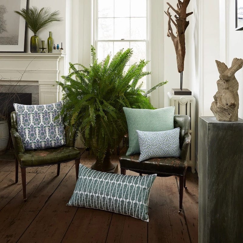 John Robshaw Maham Sage Green Throw Pillow shown with other decorative pillows in a luxurious room.