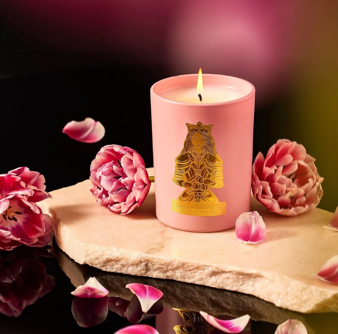 Saint Joan of Arc Candle - SAINT CANDLES shown with flower at Fig Linens and Home