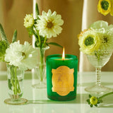 Saint Jude Special Edition Candle by SAINT CANDLES - Saint of Impossible Causes shown with flowers