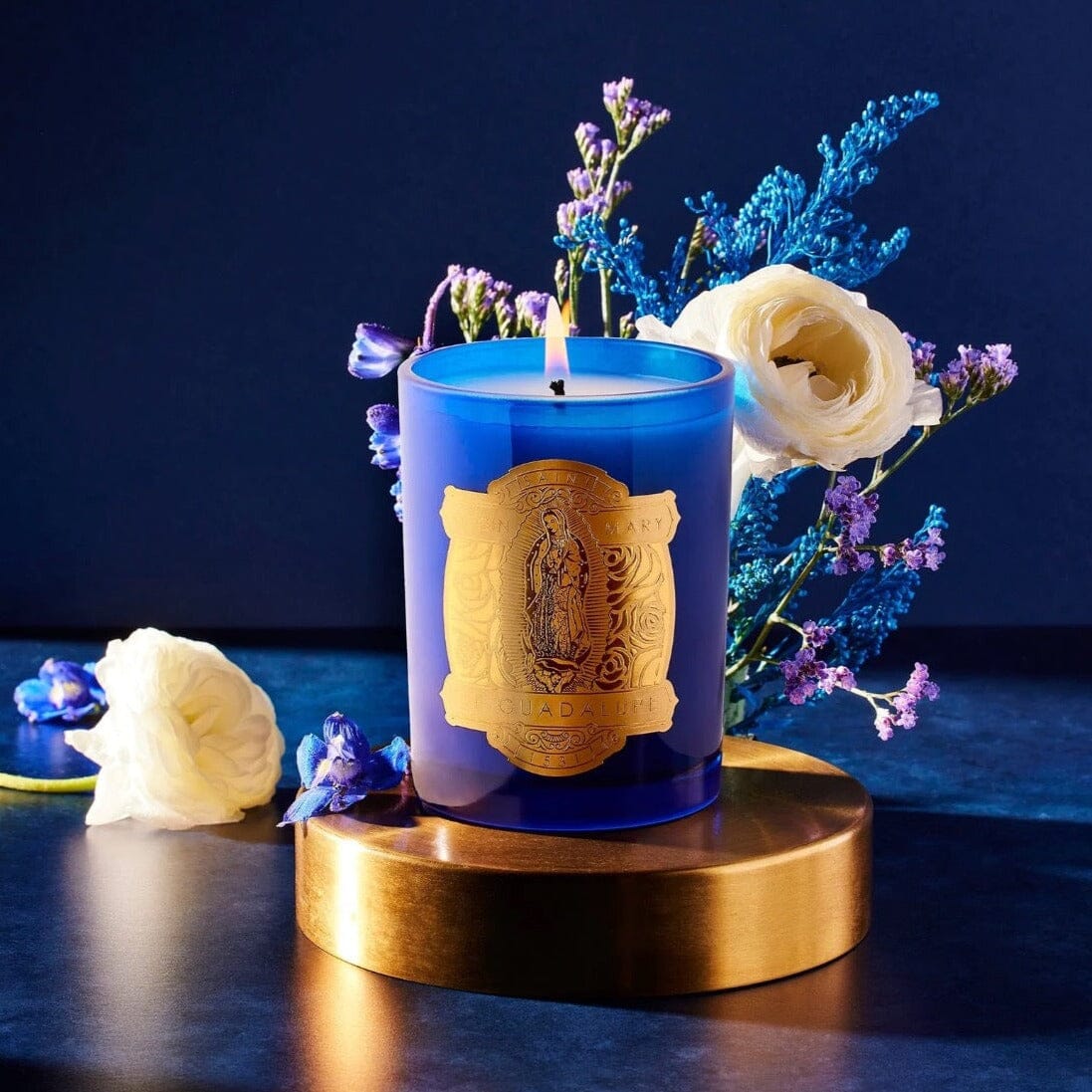 Virgin Mary of Guadalupe Special Edition Candle by SAINT CANDLES with Flowers on Pedestal