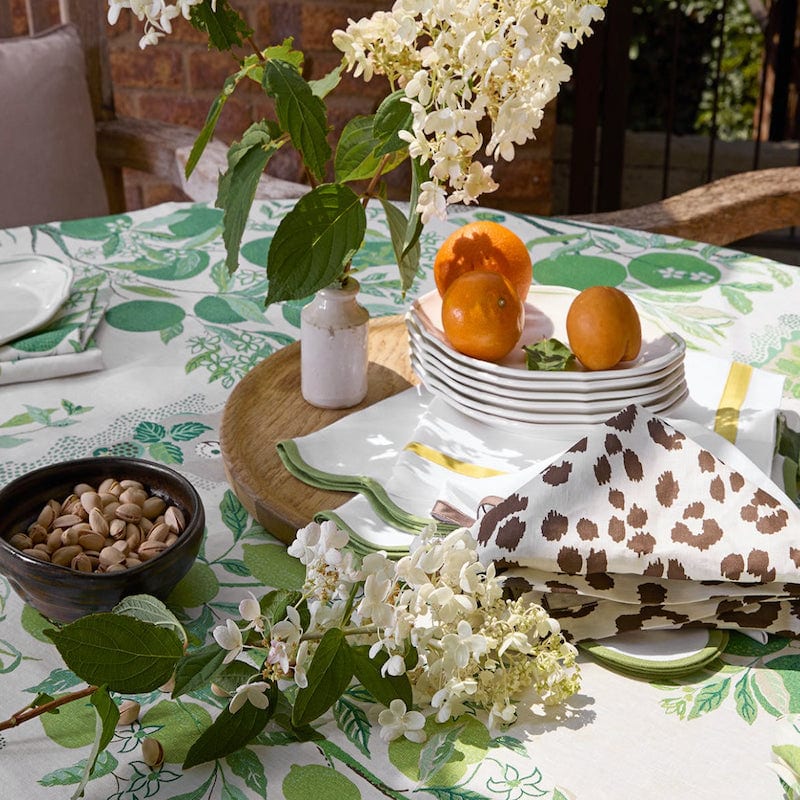 Iconic Leopard Cinder Brown Napkins by Matouk Schumacher shown with Green Tablecloth - Lifestyle 2